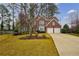 Charming two-story red brick home with well-manicured lawn and a two-car garage at 2720 Stillwater Lake Ln, Marietta, GA 30066