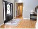 Inviting foyer with a decorative front door, hardwood floors, and a neutral color scheme creating an elegant and welcoming entry at 2720 Stillwater Lake Ln, Marietta, GA 30066