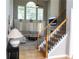 Bright living room featuring soaring ceilings, large windows, a cozy seating area and staircase with decorative iron spindles at 2720 Stillwater Lake Ln, Marietta, GA 30066