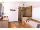 Luxurious bathroom features a glass-enclosed shower, a separate soaking tub, and double sinks with granite countertops at 2720 Stillwater Lake Ln, Marietta, GA 30066
