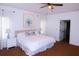Serene bedroom with plush carpet, neutral colors, a ceiling fan, and abundant natural light from large windows at 2720 Stillwater Lake Ln, Marietta, GA 30066