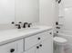 Bathroom featuring white cabinets, a matching toilet and a shower/tub combination at 7650 Abbey Glen Dr, Cumming, GA 30028