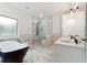 Luxurious bathroom with a freestanding tub, glass-enclosed shower, and marble accents at 7650 Abbey Glen Dr, Cumming, GA 30028
