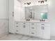 Elegant bathroom with double sinks, marble countertops, and modern fixtures at 7650 Abbey Glen Dr, Cumming, GA 30028