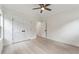 Bedroom with light wood floors, ceiling fan, closet with double doors and neutral paint at 7650 Abbey Glen Dr, Cumming, GA 30028