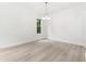 Bright bedroom featuring hardwood floors, a modern chandelier, and a large window offering natural light at 7650 Abbey Glen Dr, Cumming, GA 30028