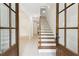 Inviting entryway with wood-trimmed staircase, creating a warm and welcoming first impression at 7650 Abbey Glen Dr, Cumming, GA 30028