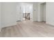 Bright hallway showing the gray washed wood flooring, neutral paint and white trim at 7650 Abbey Glen Dr, Cumming, GA 30028