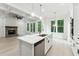 Bright, open kitchen with white cabinets, quartz countertops, and stainless steel appliances at 7650 Abbey Glen Dr, Cumming, GA 30028