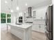 Modern kitchen featuring stainless steel appliances, white cabinetry, a kitchen island, and natural light at 7650 Abbey Glen Dr, Cumming, GA 30028