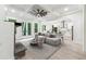 Inviting living room with a fireplace, coffered ceilings, and an open flow to the kitchen and outdoor patio at 7650 Abbey Glen Dr, Cumming, GA 30028