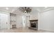 Living room featuring a stone fireplace, coffered ceiling, hardwood floors, and a built-in desk with cabinetry at 7650 Abbey Glen Dr, Cumming, GA 30028