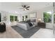 Serene main bedroom featuring natural light, neutral tones, and a comfortable king-sized bed at 7650 Abbey Glen Dr, Cumming, GA 30028