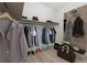 A well-organized walk-in closet features ample hanging space, shelving, and stylish accessories and handbags at 7650 Abbey Glen Dr, Cumming, GA 30028