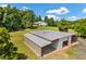Aerial view of home, outbuilding with covered parking, and tree-lined property at 195 Connesena Rd, Kingston, GA 30145