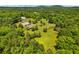 Expansive property with lush greenery, outbuildings, and a charming home nestled amidst nature at 195 Connesena Rd, Kingston, GA 30145