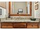 Bathroom with a wood vanity and a granite countertop, framed mirror and neutral paint at 195 Connesena Rd, Kingston, GA 30145