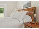 Close up of comfortable bed with plush pillows, decorative lamp and rustic headboard at 195 Connesena Rd, Kingston, GA 30145