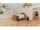 Inviting bedroom featuring hardwood floors, ceiling fan, double doors to living area and en-suite bath at 195 Connesena Rd, Kingston, GA 30145