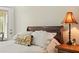 Bedroom featuring hardwood floors, natural lighting, and a cozy decorative lamp at 195 Connesena Rd, Kingston, GA 30145