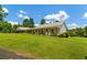 Quaint single-story home featuring a covered carport and a lush green lawn at 195 Connesena Rd, Kingston, GA 30145