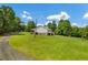 Secluded home boasts lush green lawn and surrounding trees with ample privacy at 195 Connesena Rd, Kingston, GA 30145