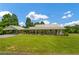 Wide view of home featuring a covered carport, landscaping, and a spacious front lawn at 195 Connesena Rd, Kingston, GA 30145