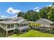 Back exterior view of home, showcasing the spacious outdoor living and carport with lush landscaping around the foundation at 195 Connesena Rd, Kingston, GA 30145