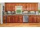 Kitchen with wood cabinets, granite counters, stainless steel appliances, and wood floors at 195 Connesena Rd, Kingston, GA 30145