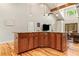 Kitchen island with wood cabinets, granite counter, pendant lights, and seating opens to living room at 195 Connesena Rd, Kingston, GA 30145