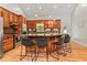 Kitchen boasts wood cabinets, granite counters, stainless steel appliances, island with bar seating, and hardwood floors at 195 Connesena Rd, Kingston, GA 30145