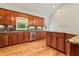 Bright kitchen features wood cabinets, granite counters, stainless steel appliances, and light wood flooring at 195 Connesena Rd, Kingston, GA 30145