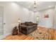 Cozy living room with a comfortable sofa and patterned pillows, with hardwood floors and bright lighting at 195 Connesena Rd, Kingston, GA 30145
