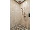 Walk-in shower featuring river rock flooring, stone look tiling, and dual shower heads at 195 Connesena Rd, Kingston, GA 30145