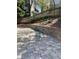 Private backyard with retaining wall and a table with chairs at 3040 Ivey Oaks Ln, Roswell, GA 30076