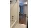 Bright bathroom with white tub, and hardwood floors at 3040 Ivey Oaks Ln, Roswell, GA 30076