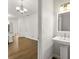 Bathroom with pedestal sink and hardwood floors at 3040 Ivey Oaks Ln, Roswell, GA 30076
