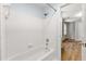 Clean bathroom featuring a bathtub with white tile surround and shower at 3040 Ivey Oaks Ln, Roswell, GA 30076