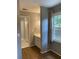 Bedroom leads to an ensuite bathroom with single vanity, framed mirror, and tub/shower combo at 3040 Ivey Oaks Ln, Roswell, GA 30076