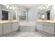 Bright bathroom with dual vanities, a soaking tub, and marble floors at 3040 Ivey Oaks Ln, Roswell, GA 30076