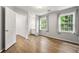 Bedroom featuring hardwood floors, natural light, and ensuite bath access at 3040 Ivey Oaks Ln, Roswell, GA 30076