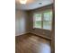 Bedroom with two windows, hardwood floors, and neutral walls at 3040 Ivey Oaks Ln, Roswell, GA 30076