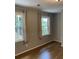 Bedroom with hardwood floors and neutral colored walls, two windows provide natural light at 3040 Ivey Oaks Ln, Roswell, GA 30076