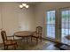 Cozy dining area with wood table, rug and view of the backyard through a window and doors at 3040 Ivey Oaks Ln, Roswell, GA 30076