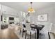 Dining room features a modern light fixture, open concept layout, and hardwood floors at 3040 Ivey Oaks Ln, Roswell, GA 30076