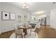 Dining area adjacent to kitchen with elegant table set and natural light at 3040 Ivey Oaks Ln, Roswell, GA 30076