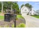 Charming two-story home with a well-manicured lawn, attractive mailbox, and a spacious driveway at 3040 Ivey Oaks Ln, Roswell, GA 30076