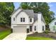 Charming two-story home with landscaped yard, attached garage, and neutral color palette at 3040 Ivey Oaks Ln, Roswell, GA 30076
