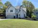 Charming two-story home with landscaped yard and attached two-car garage at 3040 Ivey Oaks Ln, Roswell, GA 30076