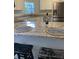 Modern kitchen features a granite countertop bar with white cabinets and stainless steel appliances at 3040 Ivey Oaks Ln, Roswell, GA 30076